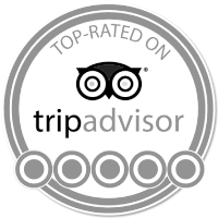 A TripAdvisor top-rated badge showing the owl logo and five circles, indicating a top rating. End.