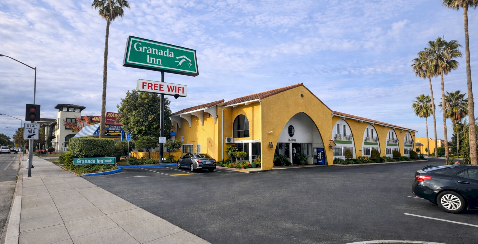 A sunny street scene shows a yellow motel with arched windows, palm trees, a parking lot, and a &ldquo;Granada Inn&rdquo; sign offering free WiFi.